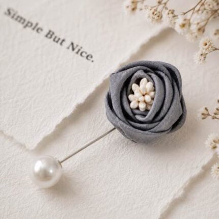 Hand-stitched flower shape brooch with layered petals and a pearl pin clasp.