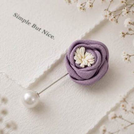 Hand-stitched flower shape brooch with layered petals and a pearl pin clasp.