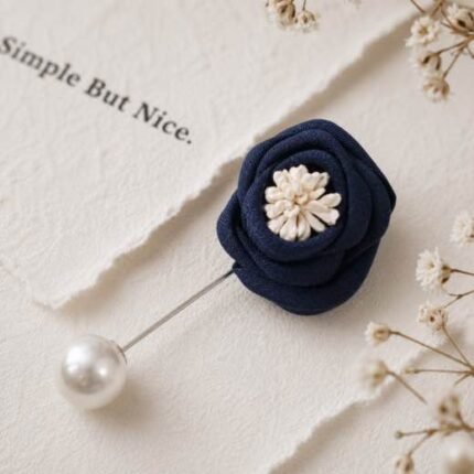 Hand-stitched flower shape brooch with layered petals and a pearl pin clasp.