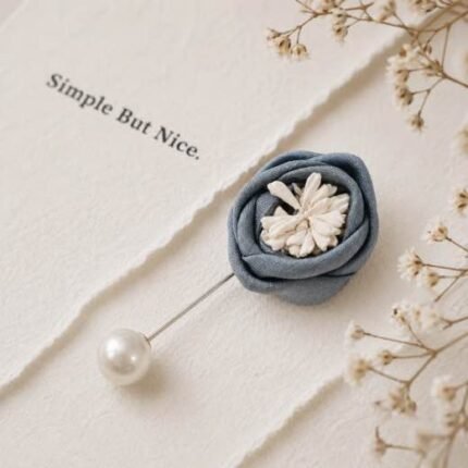 Hand-stitched flower shape brooch with layered petals and a pearl pin clasp.