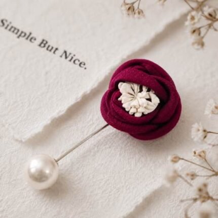 Hand-stitched flower shape brooch with layered petals and a pearl pin clasp.