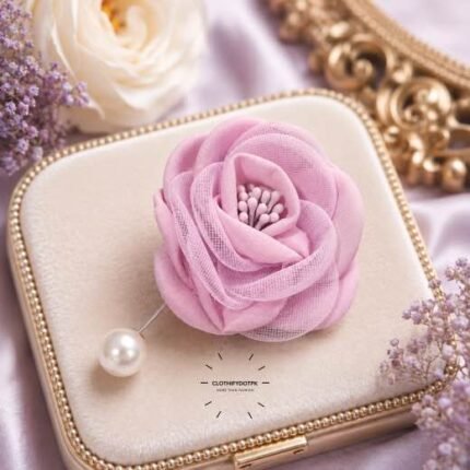 Hand-stitched flower shape brooch with layered petals and a pearl pin clasp.