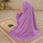 Young girl wearing a soft, breathable kids namaz chadar with comfortable sleeves, ideal for children offering namaz. BY CLOTHIFYDOTPK