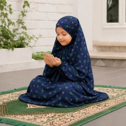 Young girl wearing a soft, breathable kids namaz chadar with comfortable sleeves, ideal for children offering namaz. BY CLOTHIFYDOTPK