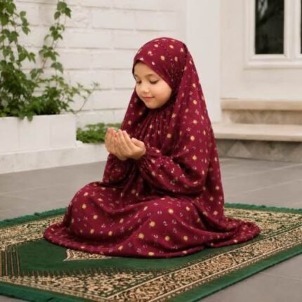 Young girl wearing a soft, breathable kids namaz chadar with comfortable sleeves, ideal for children offering namaz. BY CLOTHIFYDOTPK