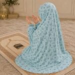 Young girl wearing a soft, breathable kids namaz chadar with comfortable sleeves, ideal for children offering namaz. BY CLOTHIFYDOTPK