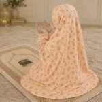 Young girl wearing a soft, breathable kids namaz chadar with comfortable sleeves, ideal for children offering namaz. BY CLOTHIFYDOTPK