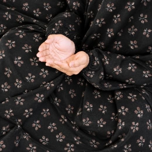 Kids Namaz Chadar(10-16) A kid wearing breathable soft swiss lawn modest coverage Namaz Chadar with sleeves, performing salah. By Clothifydotpk