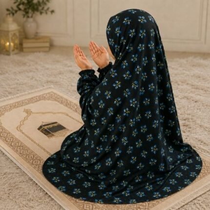 A young girl wearing a soft, lightweight kids namaz chadar with sleeves made of breathable fabric, sized perfectly for a child offering salah. BY CLOTHIFYDOTPK