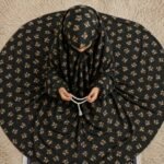 A young girl wearing a soft, lightweight kids namaz chadar with sleeves made of breathable fabric, sized perfectly for a child offering salah. BY CLOTHIFYDOTPK