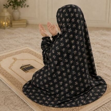 A young girl wearing a soft, lightweight kids namaz chadar with sleeves made of breathable fabric, sized perfectly for a child offering salah. BY CLOTHIFYDOTPK