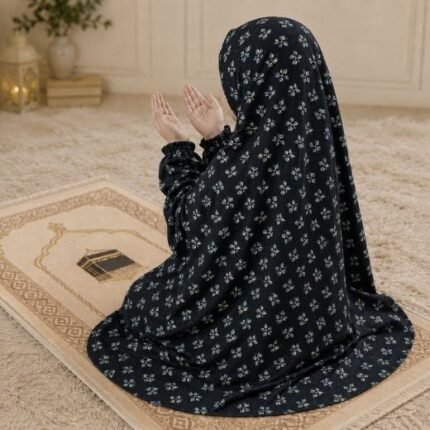 A young girl wearing a soft, lightweight kids namaz chadar with sleeves made of breathable fabric, sized perfectly for a child offering salah. BY CLOTHIFYDOTPK