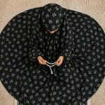 A young girl wearing a soft, lightweight kids namaz chadar with sleeves made of breathable fabric, sized perfectly for a child offering salah. BY CLOTHIFYDOTPK
