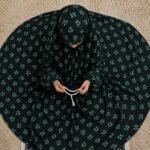 A young girl wearing a soft, lightweight kids namaz chadar with sleeves made of breathable fabric, sized perfectly for a child offering salah. BY CLOTHIFYDOTPK