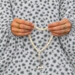 Woman wearing printed arabic namaz chadar holding prayer beads full coverage and comfort without compromising style. BY CLOTHIFYDOTPK