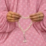 Woman wearing printed arabic namaz chadar holding prayer beads full coverage and comfort without compromising style. BY CLOTHIFYDOTPK