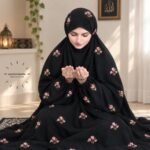 Woman wearing floral embroidered namaz chadar with sleeves for modest Islamic prayerwear. BY CLOTHIFYDOTPK