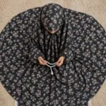 A young girl wearing a soft, lightweight kids namaz chadar with sleeves made of breathable fabric, sized perfectly for a child offering salah. BY CLOTHIFYDOTPK