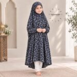 A young girl wearing a soft, lightweight kids namaz chadar with sleeves made of breathable fabric, sized perfectly for a child offering salah. BY CLOTHIFYDOTPK