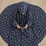 A young girl wearing a soft, lightweight kids namaz chadar with sleeves made of breathable fabric, sized perfectly for a child offering salah. BY CLOTHIFYDOTPK