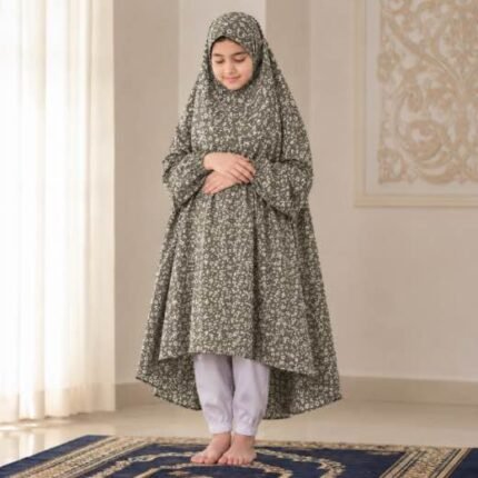 A kid wearing breathable soft swiss lawn modest coverage Namaz Chadar with sleeves, performing salah. By Clothifydotpk