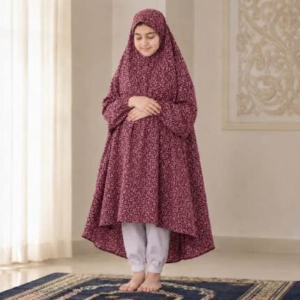 A kid wearing breathable soft swiss lawn modest coverage Namaz Chadar with sleeves, performing salah. By Clothifydotpk