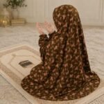 Young girl wearing a soft, breathable kids namaz chadar with comfortable sleeves, ideal for children offering namaz. BY CLOTHIFYDOTPK
