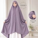 A woman standing for Salah comfortably in a breathable, soft Swiss lawn Namaz Chadar with sleeves- available at CLOTHIFYDOTPK