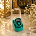A medium, handheld digital LED tally counter used for tasbeeh, with a simple display showing the current count and a button on top to increment it. BY CLOTHIFYDOTPK