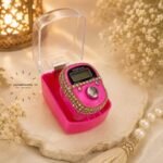 A medium, handheld digital embellished LED tally counter used for tasbeeh, with a simple display showing the current count and a button on top to increment it. BY CLOTHIFYDOTPK