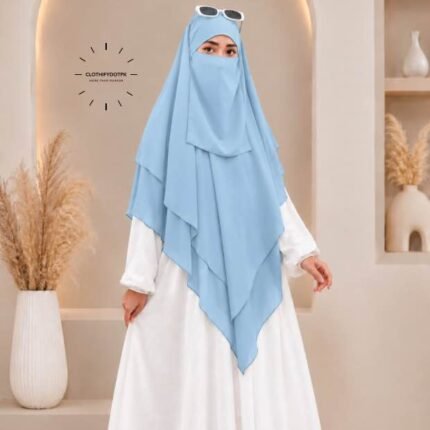 A woman wearing a three layer khimar, with the first layer covering her head and draping down over her chest, and two additional sheer or lightweight layers cascading underneath. BY CLOTHIFYDOTPK