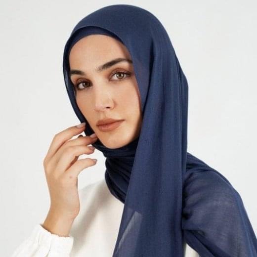 A woman comfortably wearing a modal hijab, highlighting the fabric's fluid drape. Clothifydotpk